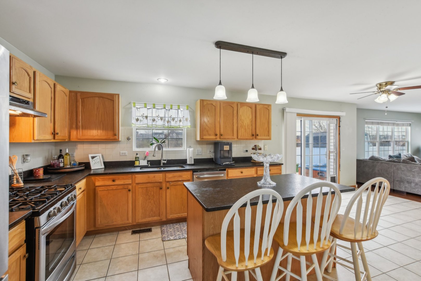 1608 Prairieview Boulevard Bolingbrook, IL 60490 - Photo 16 of 55 a kitchen with stainless steel appliances a sink a stove a table and chairs