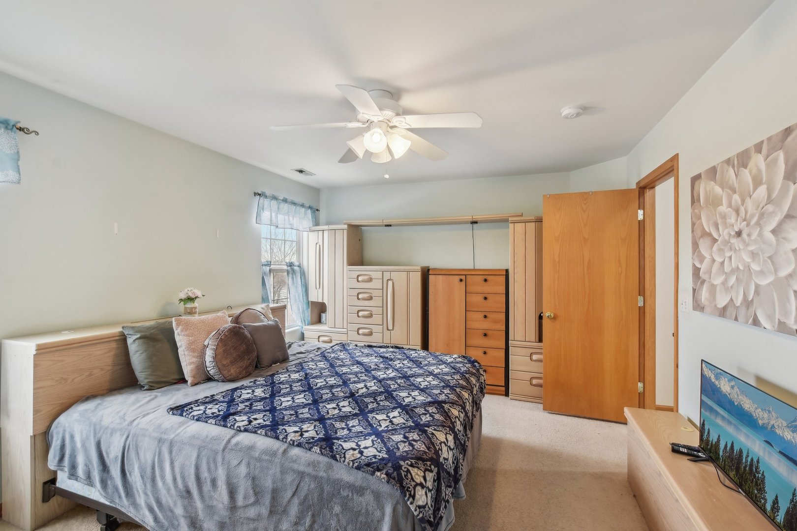 1608 Prairieview Boulevard Bolingbrook, IL 60490 - Photo 25 of 55 a bedroom with a large bed and a chandelier