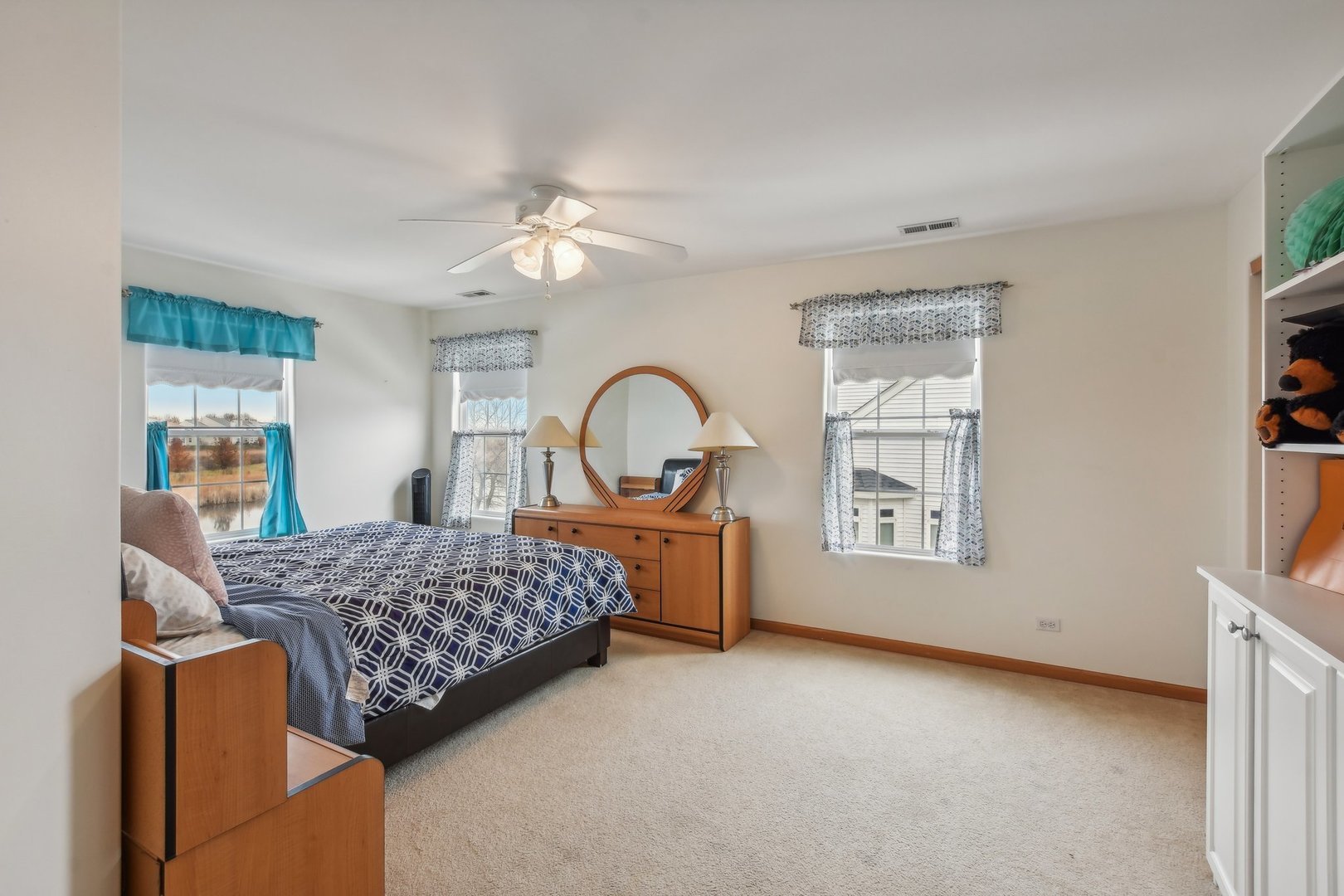 1608 Prairieview Boulevard Bolingbrook, IL 60490 - Photo 30 of 55 a bedroom with a bed next to a window with workspace