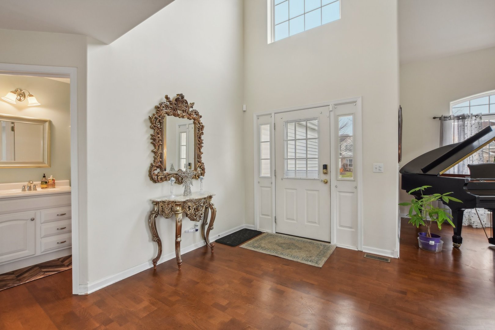 1608 Prairieview Boulevard Bolingbrook, IL 60490 - Photo 4 of 55 a view of a hallway with entryway wooden floor and windows