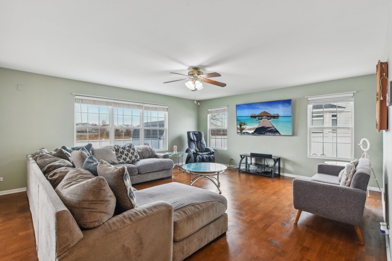 1608 Prairieview Boulevard Bolingbrook, IL 60490 - Photo 10 of 55 a living room with furniture a large window and a flat screen tv