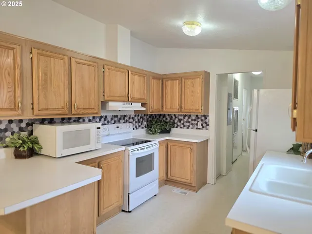 a kitchen with stainless steel appliances white cabinets and a sink