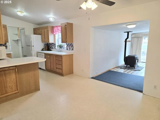a kitchen with kitchen island granite countertop a sink stainless steel appliances and cabinets