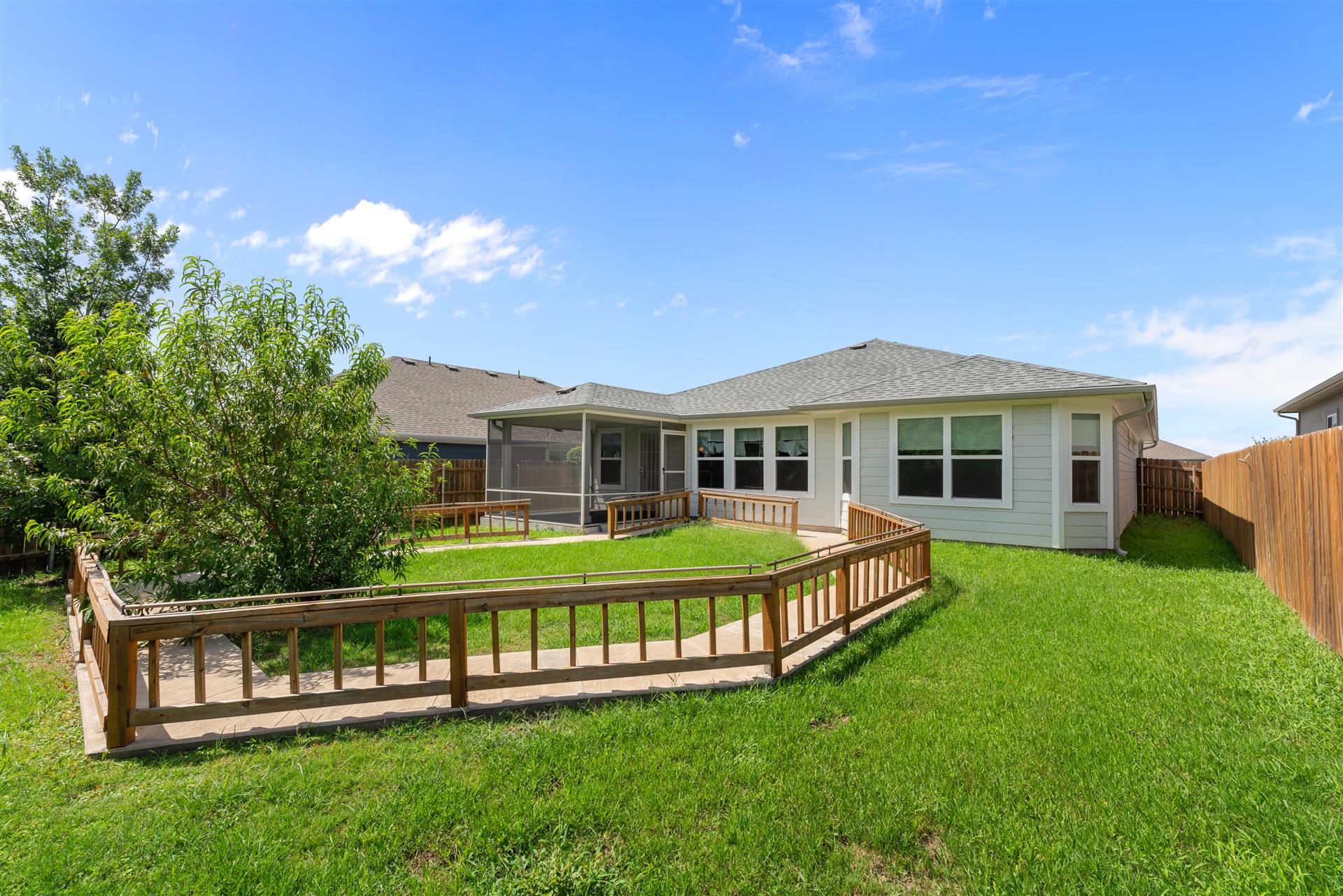 16512 Enamorado Road Manor, TX 78653 - Photo 30 of 31 A well-maintained lawn surrounds this charming home with a practical ramp leading to a screened porch.