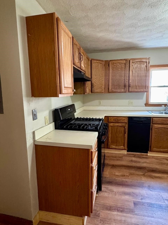 68 Maverick Street Chelsea, MA 02150 - Photo 4 of 16 a kitchen with stainless steel appliances granite countertop a stove a sink and a refrigerator