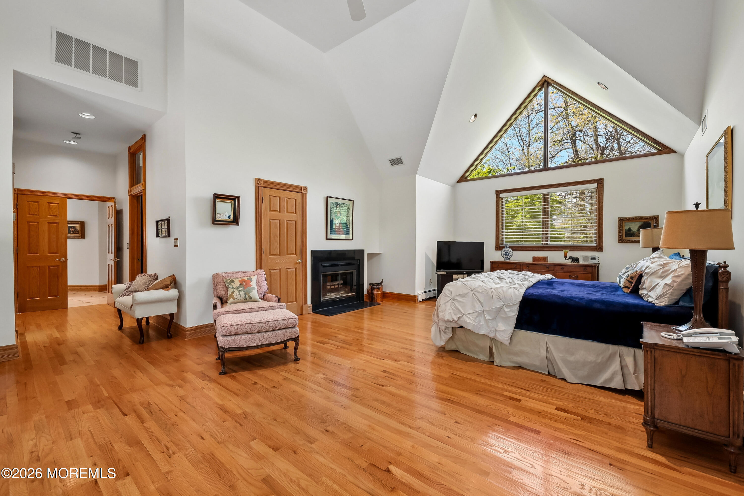 187 Hockhockson Road Colts Neck, NJ 07722 - Photo 27 of 55 a bedroom with furniture and a fireplace