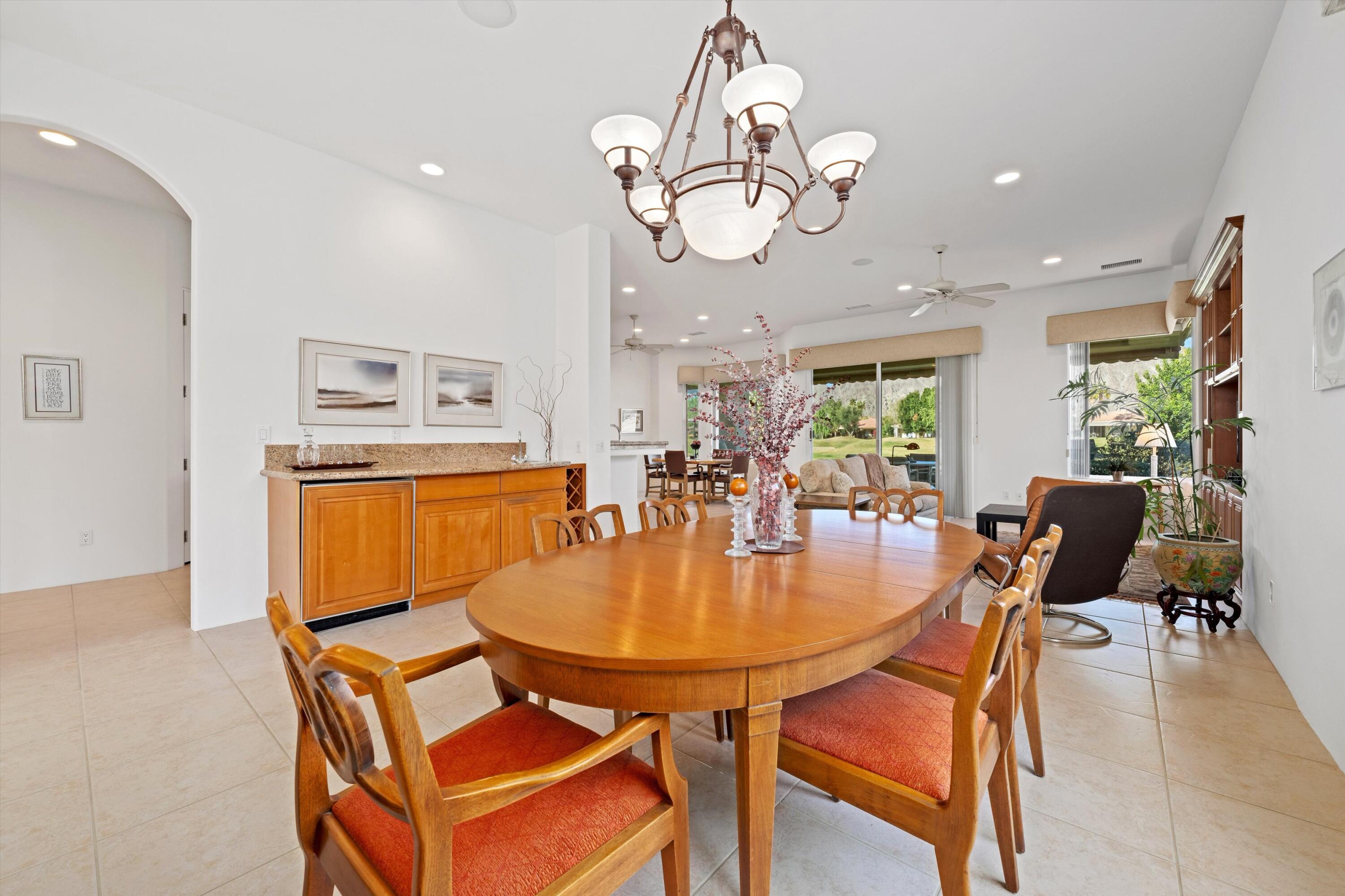 55151 Laurel Valley La Quinta, CA 92253 - Photo 20 of 43 a dining room filled chandelier and a dining table
