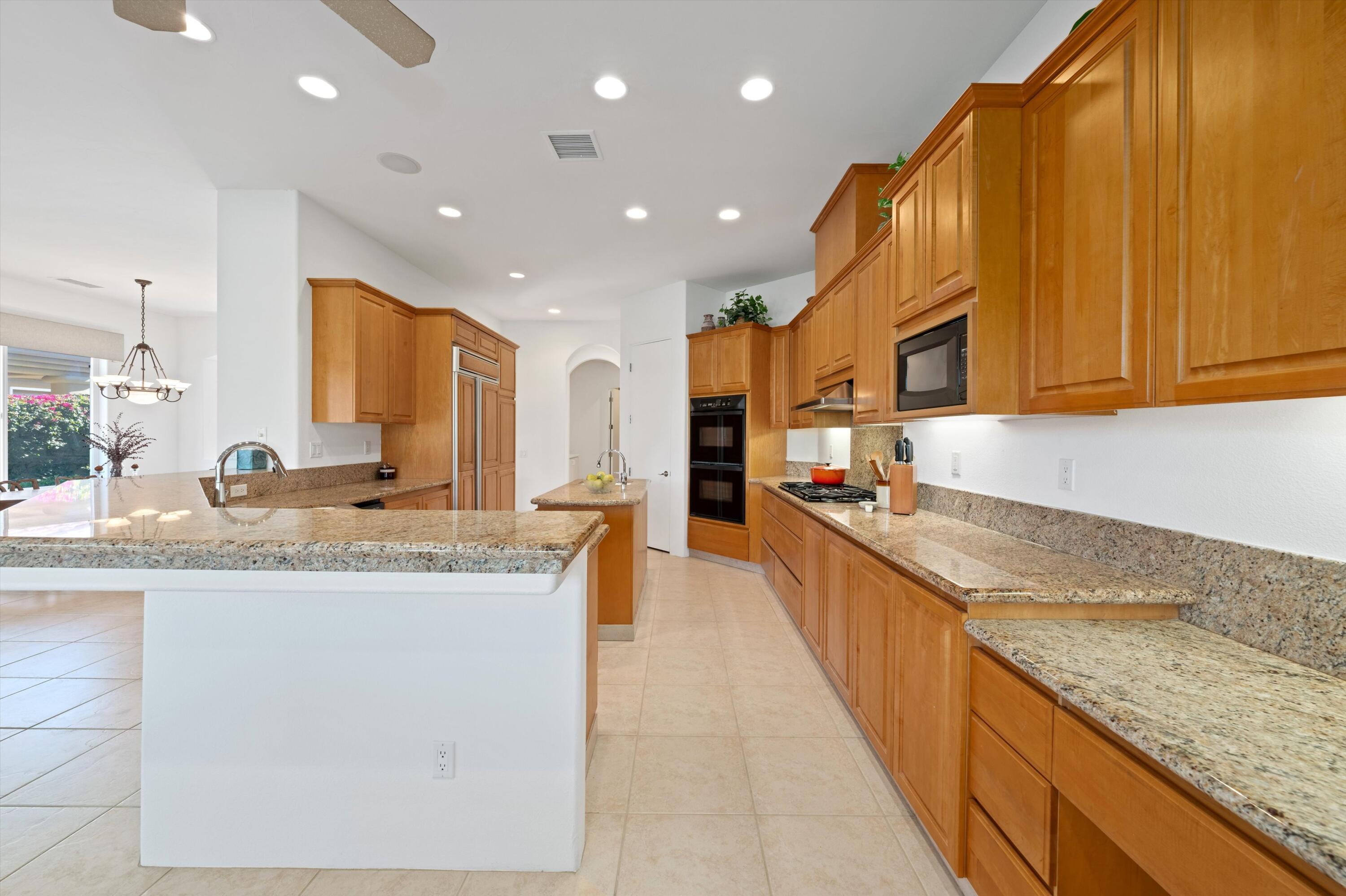 55151 Laurel Valley La Quinta, CA 92253 - Photo 25 of 43 a large kitchen with granite countertop lots of counter space and a sink