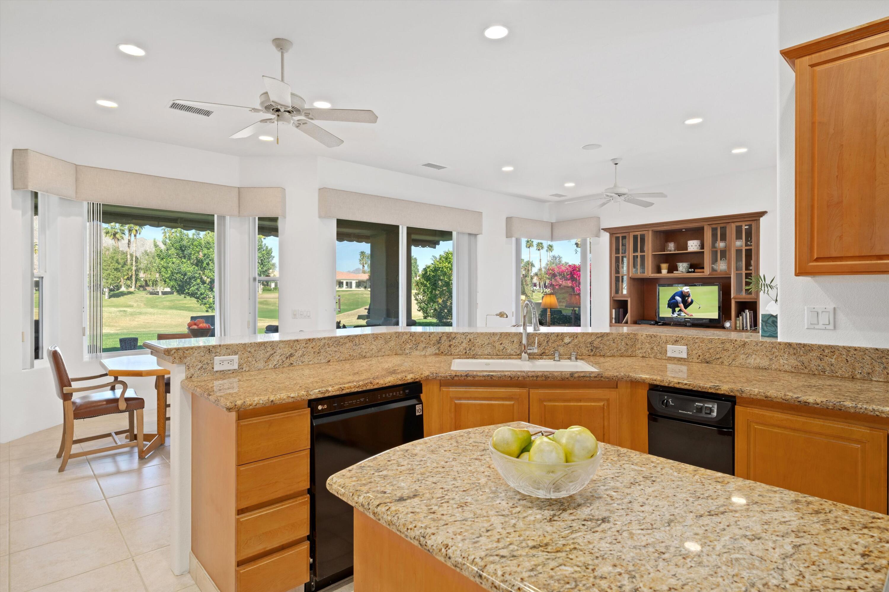 55151 Laurel Valley La Quinta, CA 92253 - Photo 27 of 43 a kitchen with a stove a sink and a refrigerator