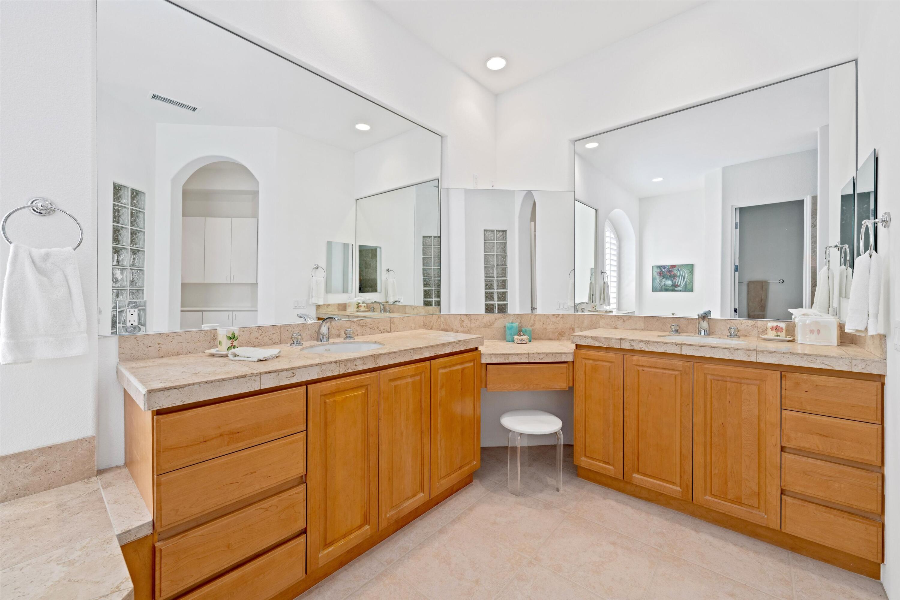 55151 Laurel Valley La Quinta, CA 92253 - Photo 32 of 43 a bathroom with a granite countertop sink mirror and bathtub