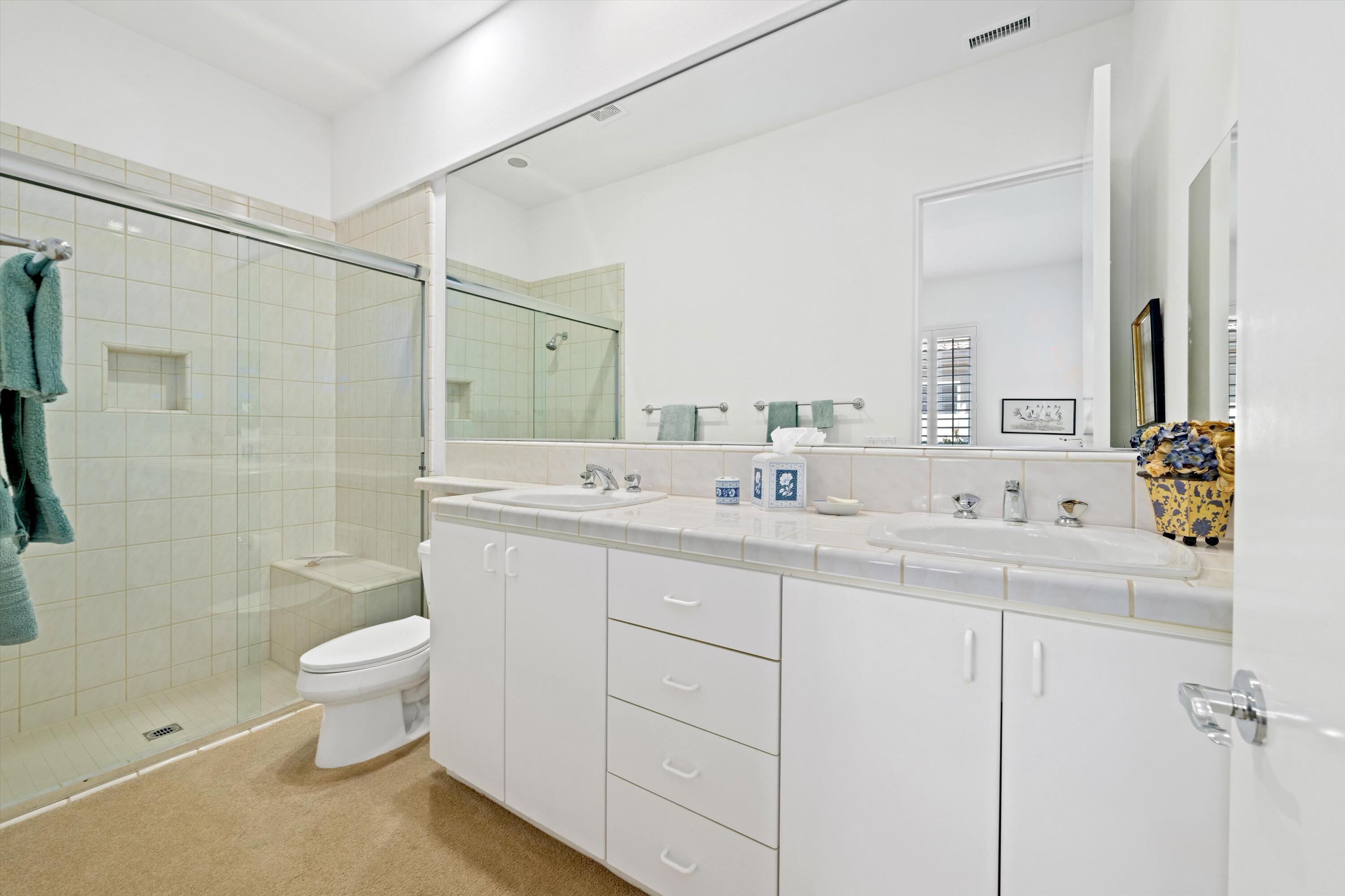 55151 Laurel Valley La Quinta, CA 92253 - Photo 39 of 43 a bathroom with a double vanity sink toilet and shower
