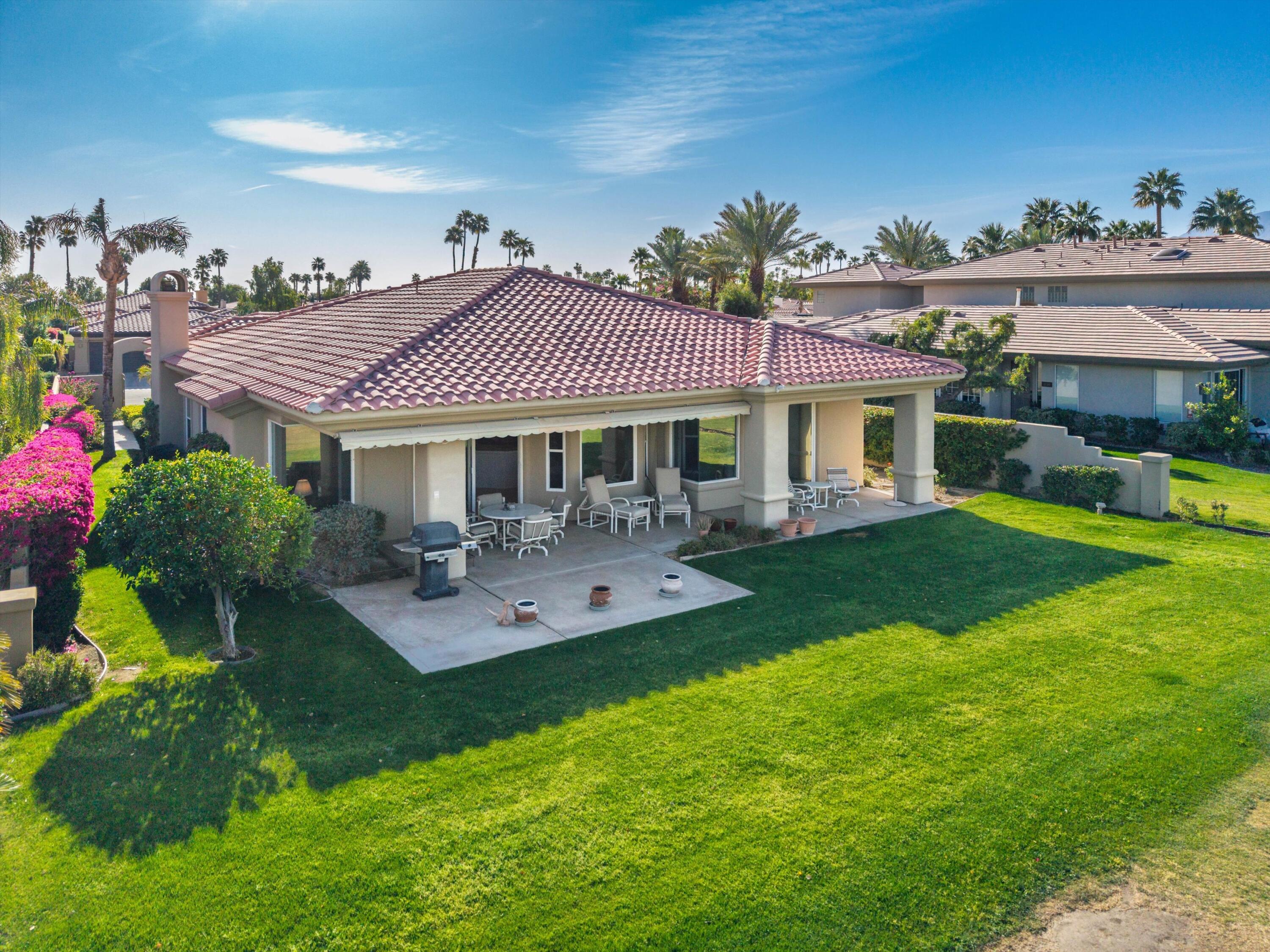 55151 Laurel Valley La Quinta, CA 92253 - Photo 9 of 43 a front view of a house with yard and green space