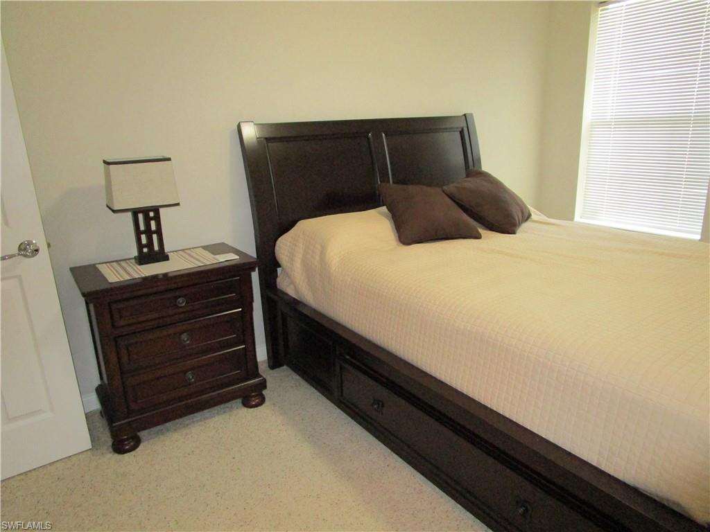 8677 Erice Court Naples, FL 34114 - Photo 15 of 42 a bedroom with a bed and a night stand