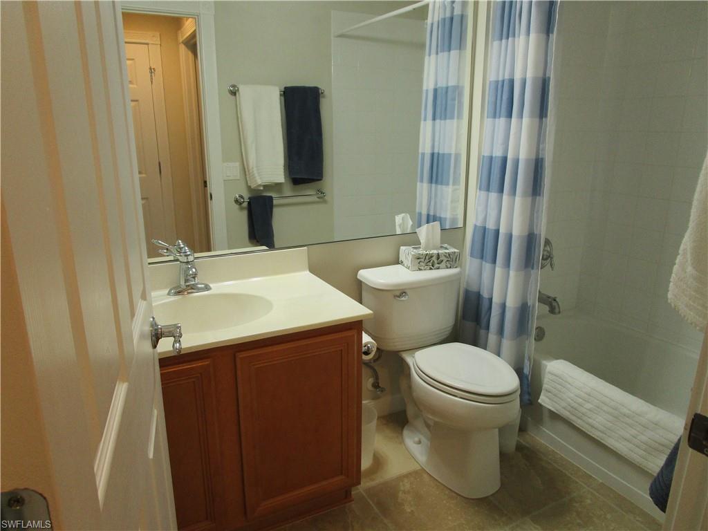 8677 Erice Court Naples, FL 34114 - Photo 17 of 42 a bathroom with a toilet sink and mirror