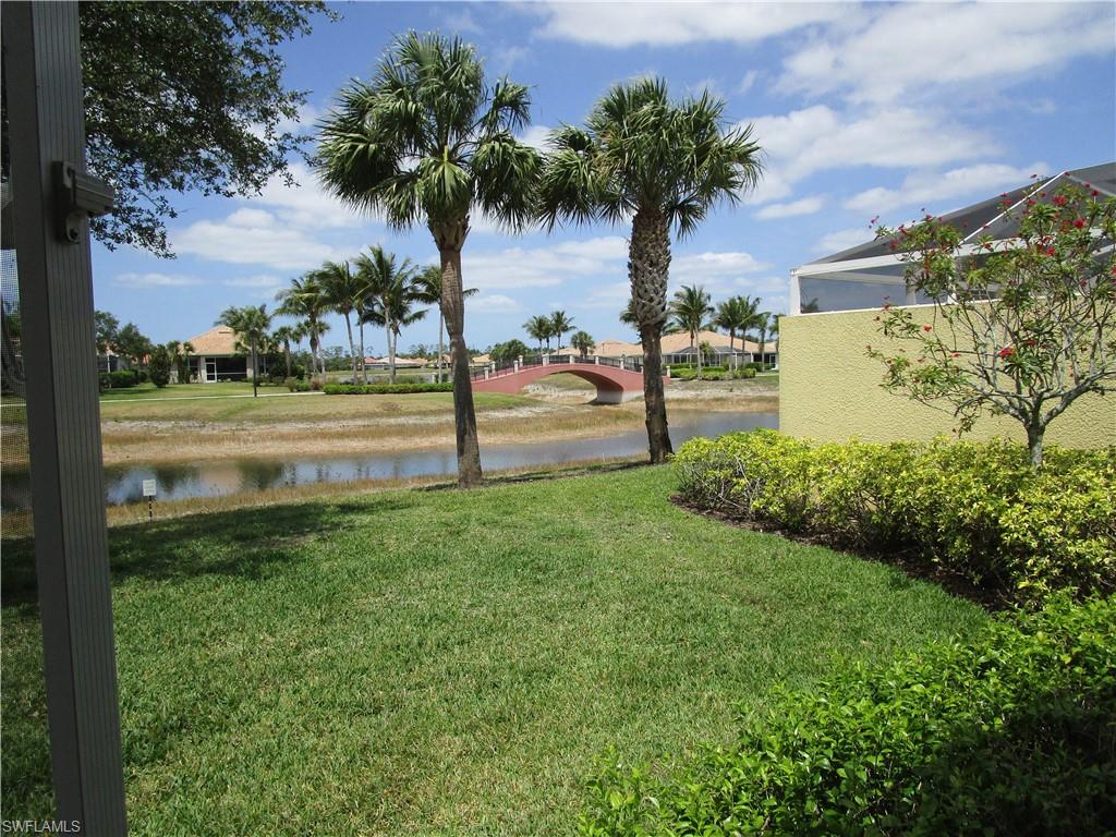 8677 Erice Court Naples, FL 34114 - Photo 18 of 42 a view of a garden with a lake