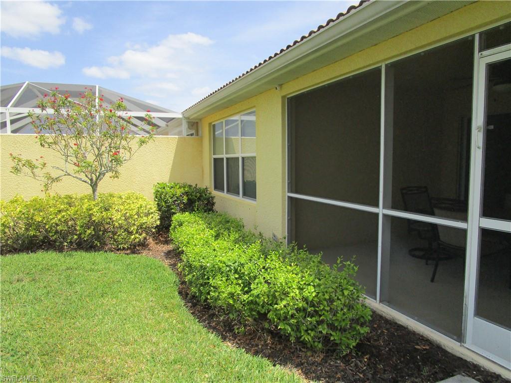 8677 Erice Court Naples, FL 34114 - Photo 19 of 42 a view of a house with a backyard