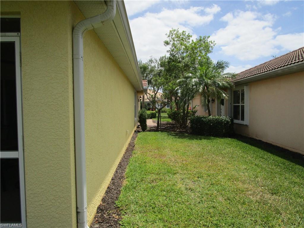 8677 Erice Court Naples, FL 34114 - Photo 20 of 42 a view of a backyard