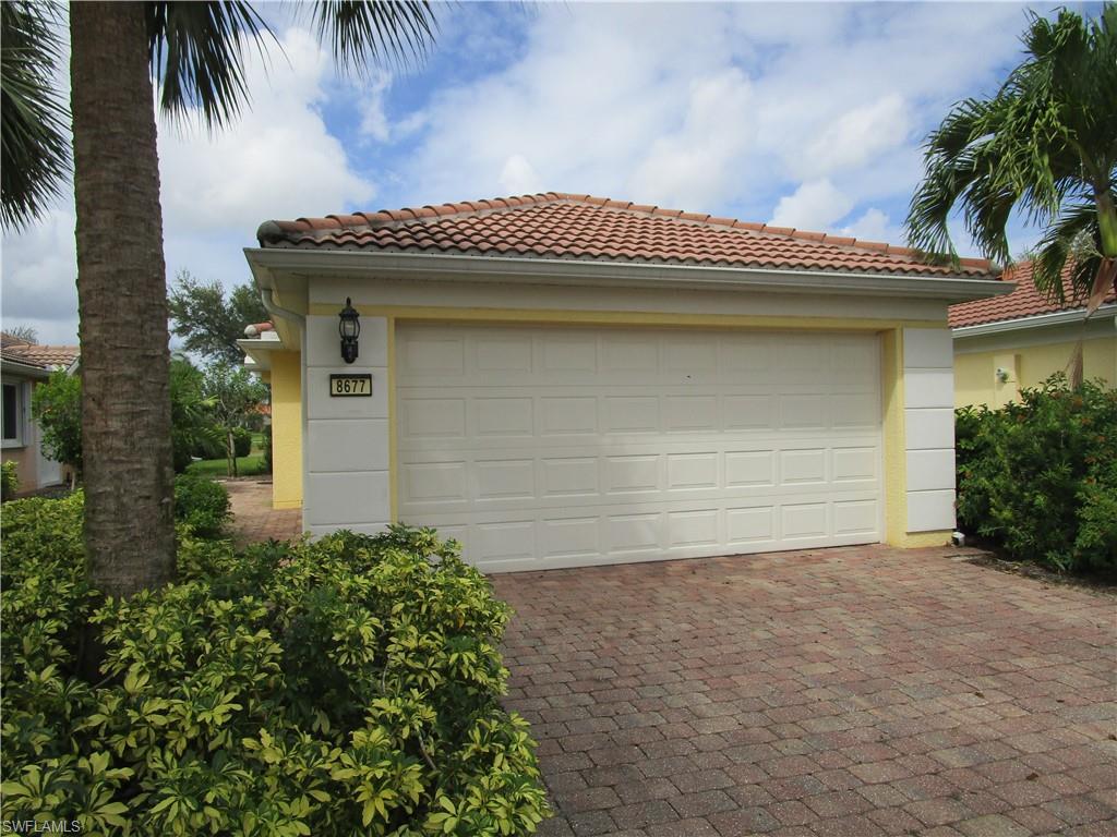 8677 Erice Court Naples, FL 34114 - Photo 21 of 42 a front view of a house with a garage