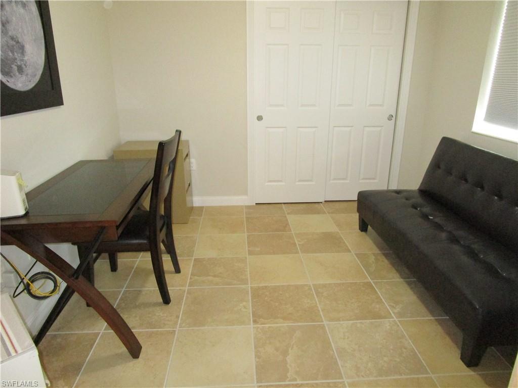 8677 Erice Court Naples, FL 34114 - Photo 26 of 42 a view of a workspace with furniture and a window