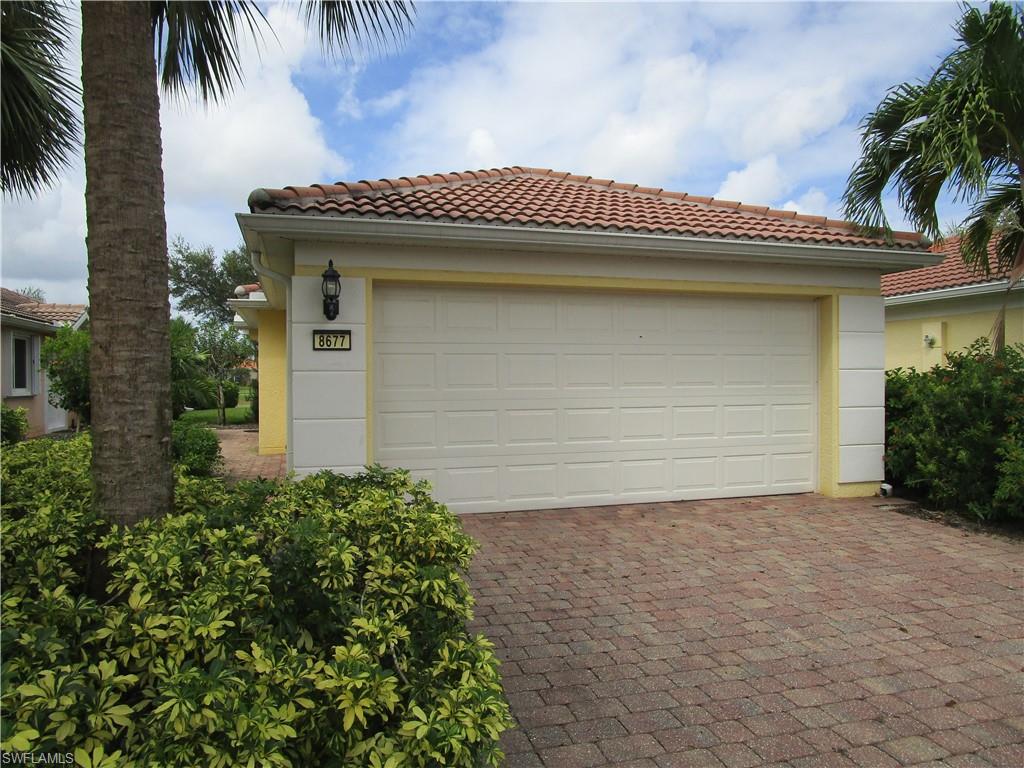 8677 Erice Court Naples, FL 34114 - Photo 3 of 42 a front view of a house with a garage
