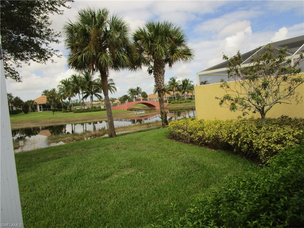 8677 Erice Court Naples, FL 34114 - Photo 33 of 42 View of grassy yard with a water view