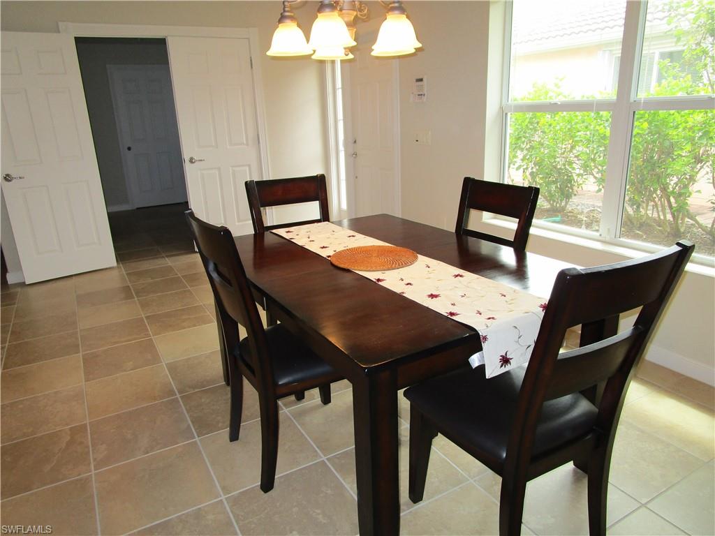 8677 Erice Court Naples, FL 34114 - Photo 38 of 42 a view of a dining room with furniture and window
