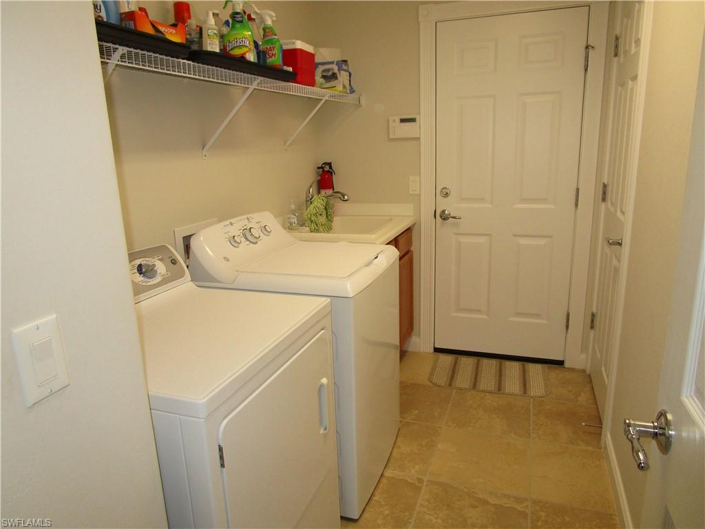 8677 Erice Court Naples, FL 34114 - Photo 40 of 42 a utility room with dryer and washer