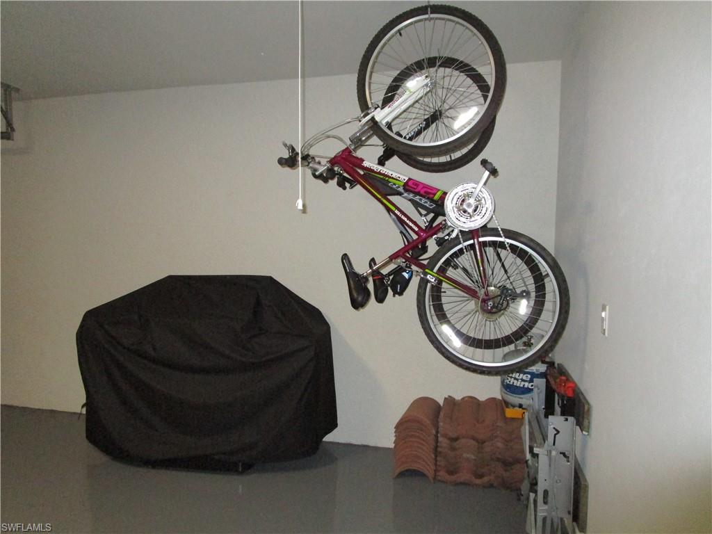 8677 Erice Court Naples, FL 34114 - Photo 41 of 42 a view of a storage and utility room with washer and dryer