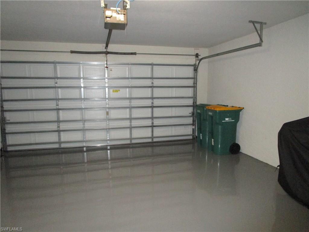 8677 Erice Court Naples, FL 34114 - Photo 42 of 42 Garage featuring a garage door opener
