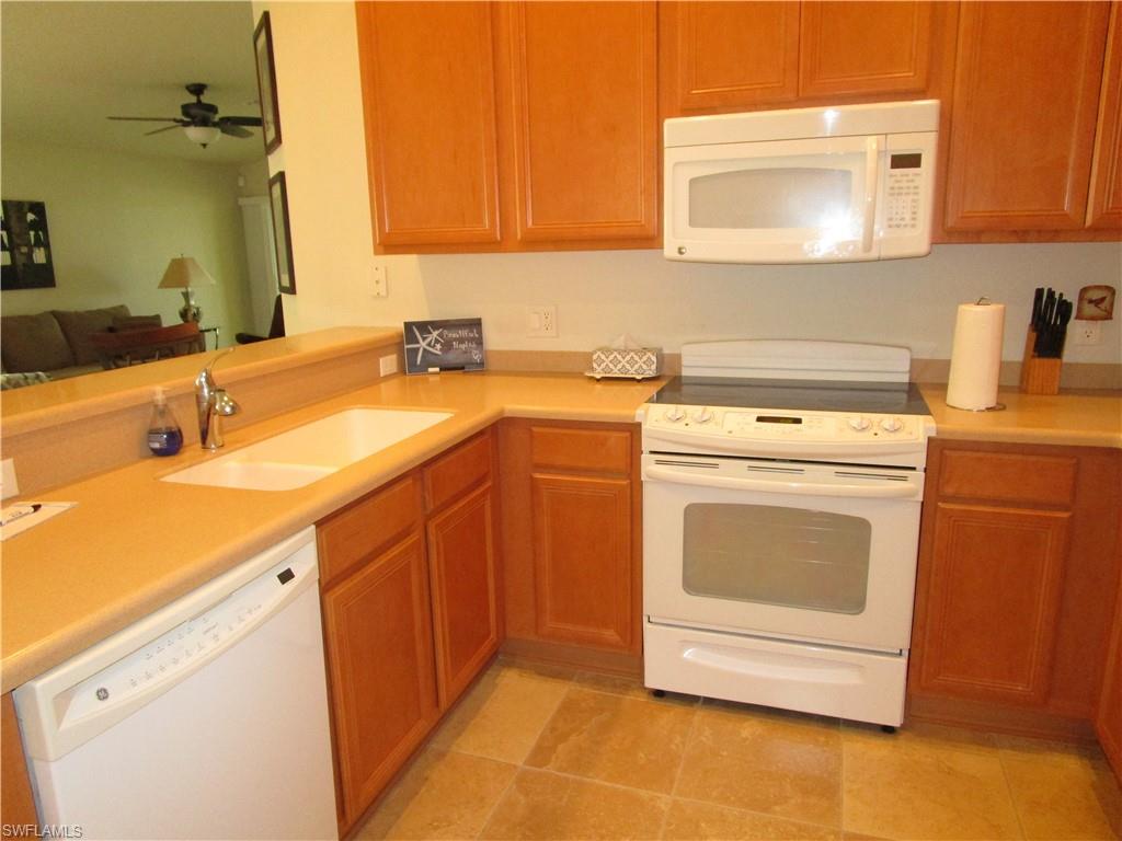 8677 Erice Court Naples, FL 34114 - Photo 7 of 42 a utility room with sink dryer and washer