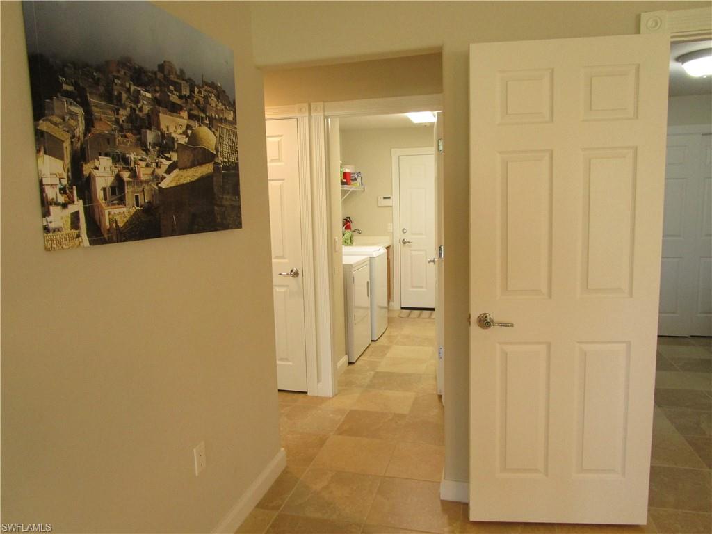8677 Erice Court Naples, FL 34114 - Photo 10 of 42 a view of a hallway with painted walls