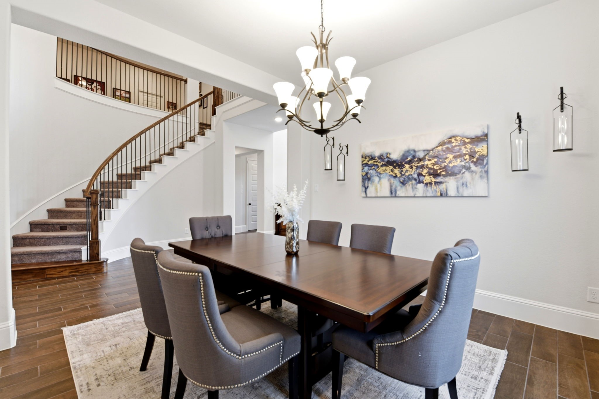 10062 South Goshawk Trail Conroe, TX 77385 - Photo 7 of 43 a view of a dining room with furniture wooden floor and chandelier