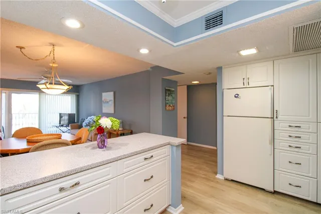 a kitchen with stove a microwave and cabinets