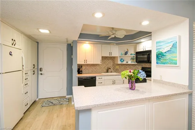 a kitchen with a sink and refrigerator