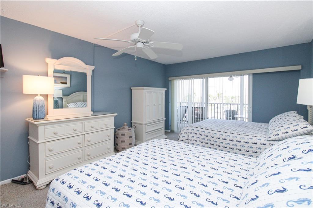 1 Bluebill Avenue, Unit 501 Naples, FL 34108 - Photo 17 of 38 a bedroom with a large bed and a window