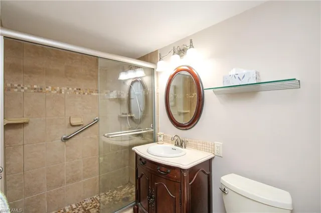 a bathroom with a toilet a sink and a mirror