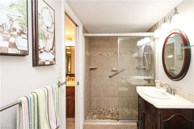 a bathroom with a granite countertop sink vanity and mirror
