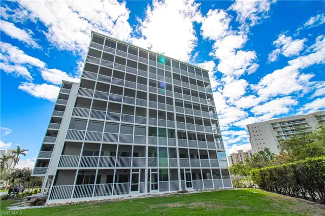 a view of a hallway and a dining room with furniture