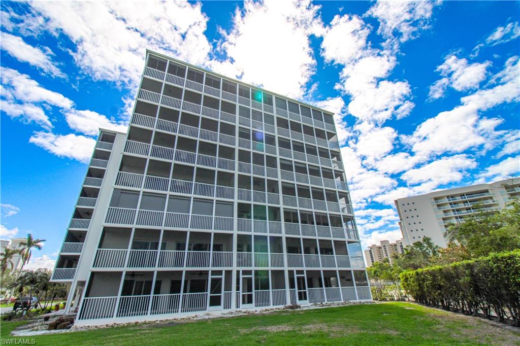 1 Bluebill Avenue, Unit 501 Naples, FL 34108 - Photo 27 of 38 a view of a building with a yard