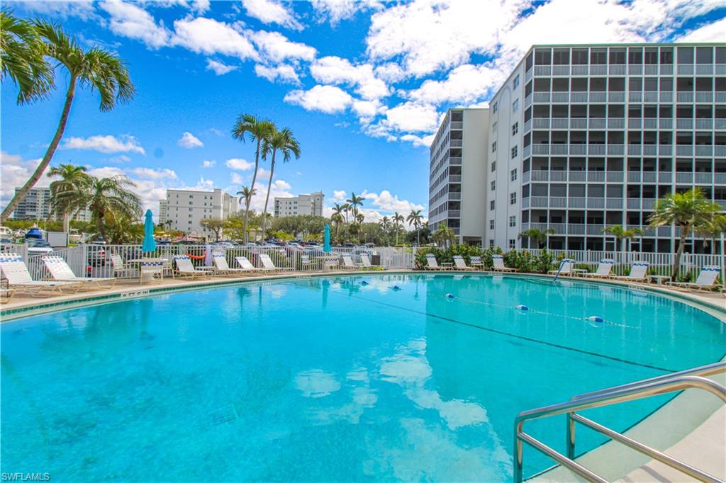 1 Bluebill Avenue, Unit 501 Naples, FL 34108 - Photo 29 of 38 a view of a swimming pool with outdoor seating