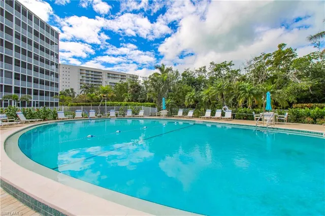 a view of a swimming pool with outdoor seating