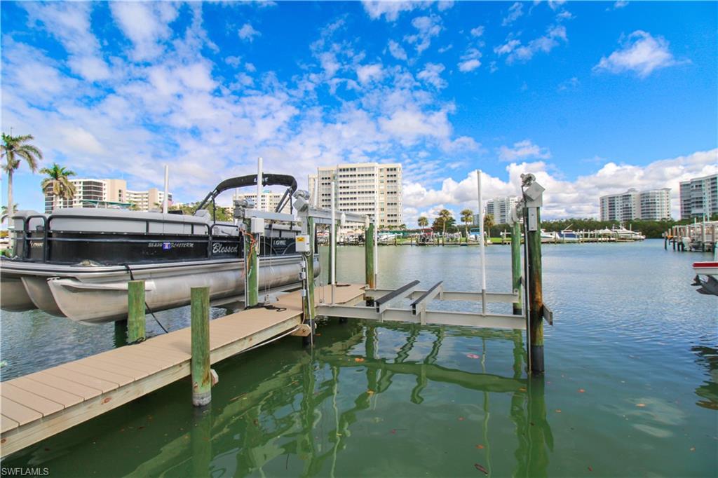 1 Bluebill Avenue, Unit 501 Naples, FL 34108 - Photo 34 of 38 a roof deck with table and chairs