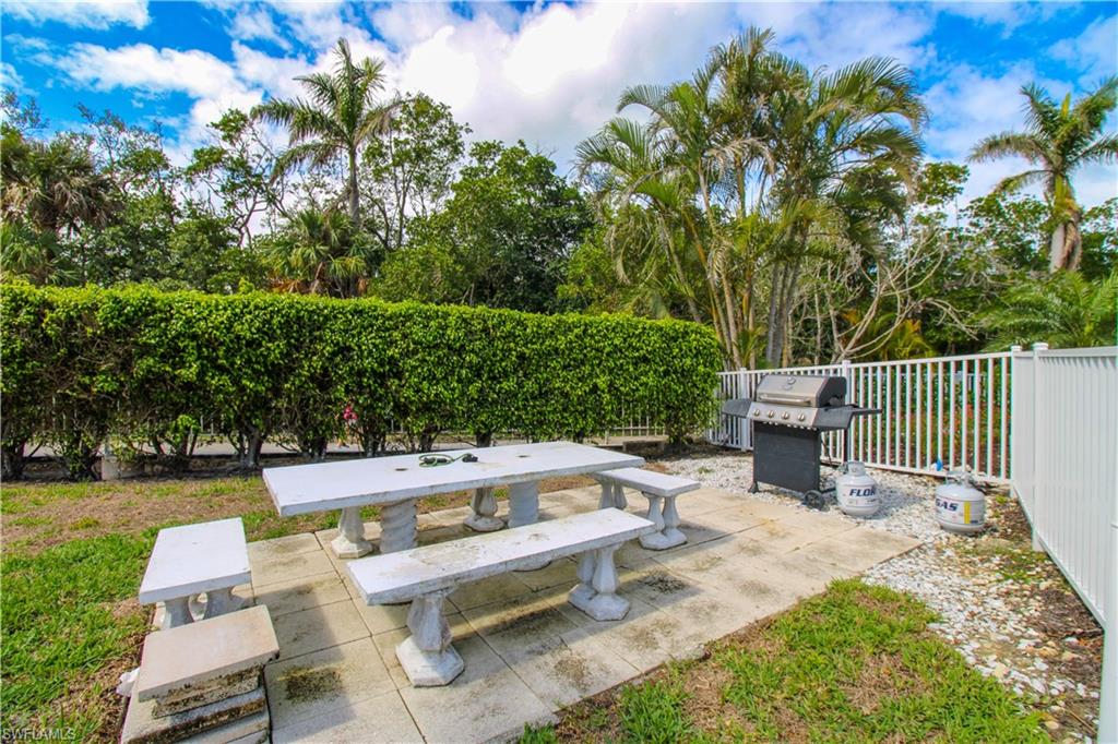 1 Bluebill Avenue, Unit 501 Naples, FL 34108 - Photo 35 of 38 a view of backyard with seating area and green space
