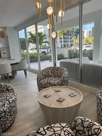a living room with furniture and a dining table with wooden floor