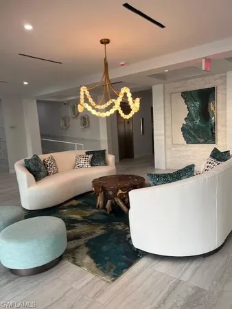 a view of a livingroom with furniture and floor to ceiling window