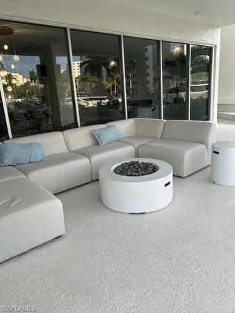 a living room with furniture a rug and a chandelier