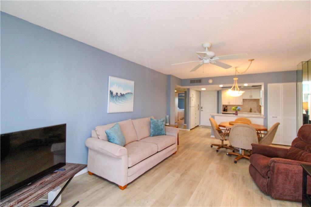 1 Bluebill Avenue, Unit 501 Naples, FL 34108 - Photo 6 of 38 a living room with furniture and a flat screen tv