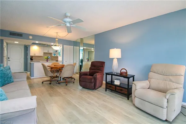 a living room with furniture and a lamp