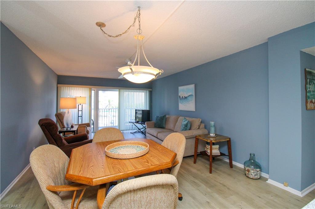 1 Bluebill Avenue, Unit 501 Naples, FL 34108 - Photo 9 of 38 a table and chairs in a room