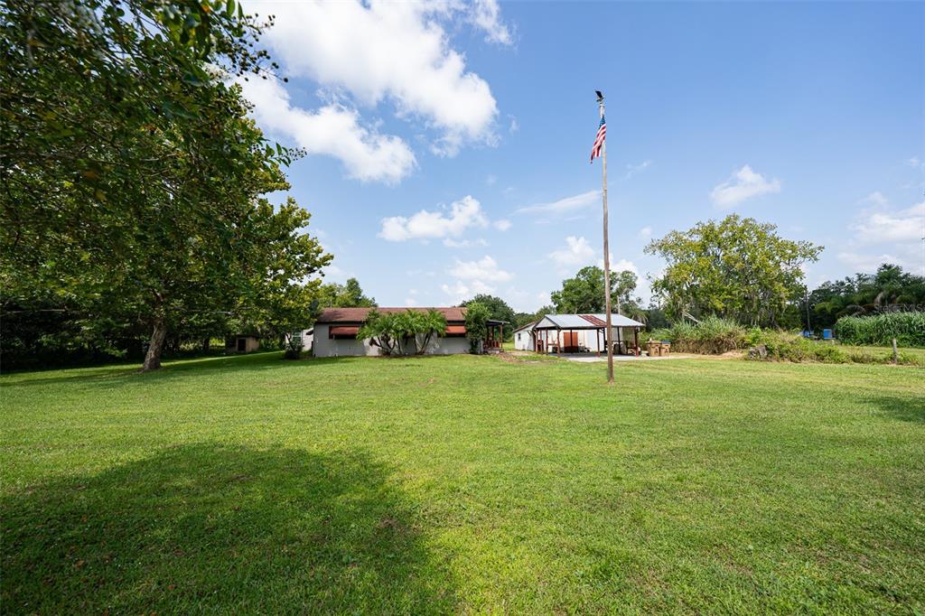 4260 Lippman Road St. Cloud, FL 34772 - Photo 1 of 1 a house with a big yard and large trees